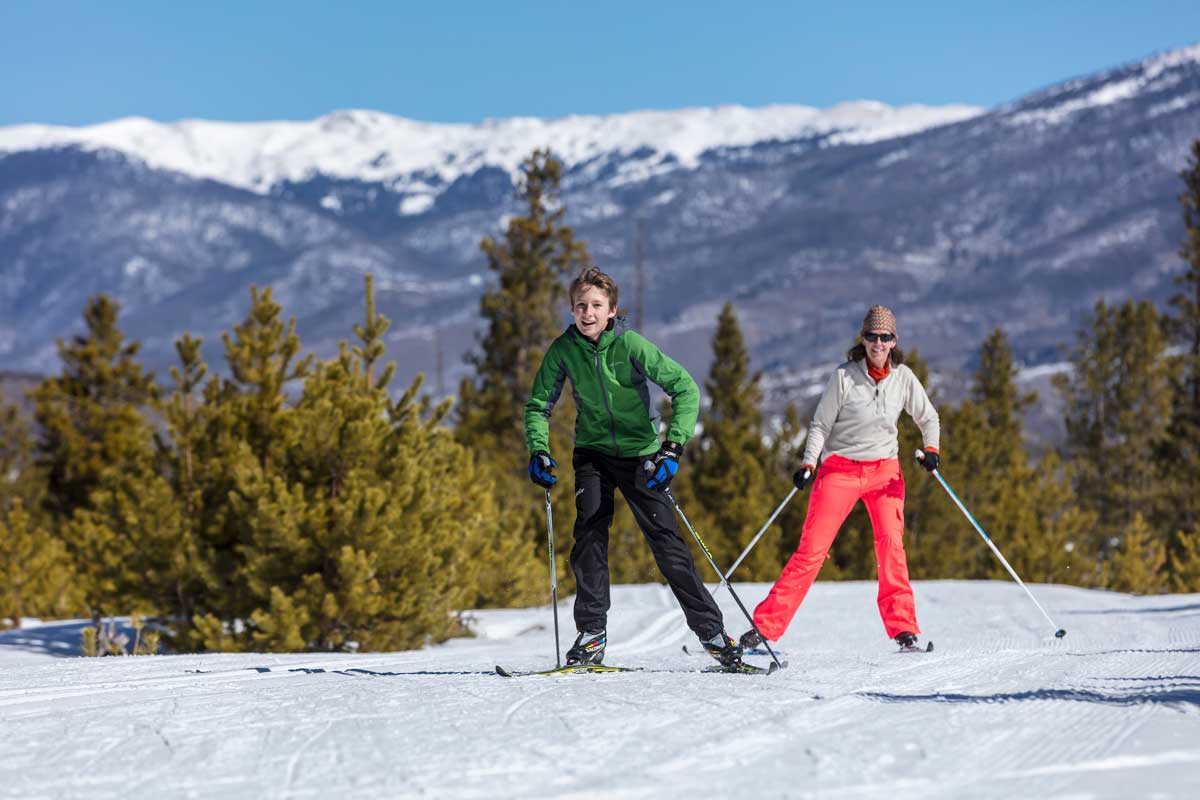 Young boy and his mother nordic skiing